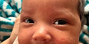 Jasmine is registered to the contest to win money with this photo: baby, infant, smiling, face, closeup, pink_clothing, blanket, patterned_blanket, happy, cute, child, portrait, skin, hair, eyes, mouth, expression, indoor, soft, young