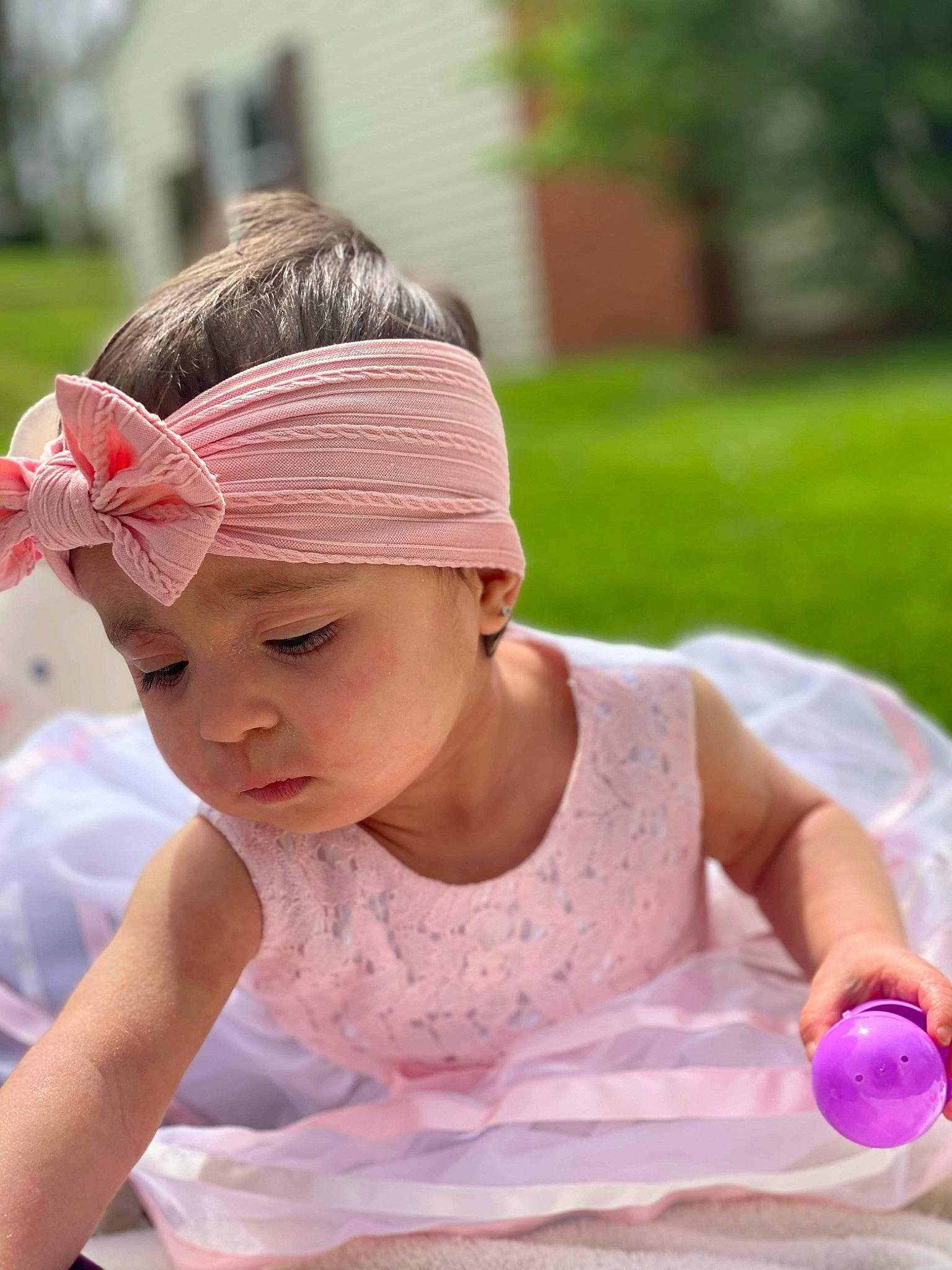 Anya is registered to the contest to win money with this photo: baby, baby_toddler_clothing, cap, child, fashion_accessory, fun, grass, hair_accessory, happy, headband, headpiece, headwear, leisure, magenta, pattern, peach, person, photograph, pink, recreation
