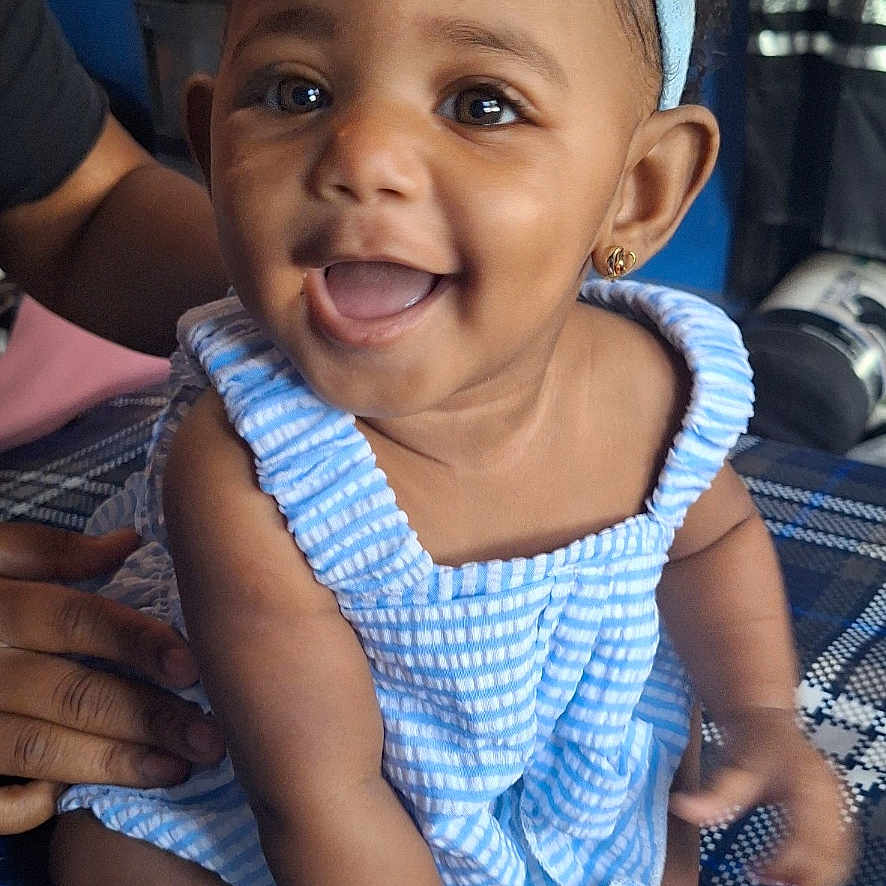 Mei'Lanii joined the competition — help win amazing prizes! baby, blue_dress, child, cute, earrings, eyes, face, feet, hands, happy, headband, indoor, infant, mouth, patterned_surface, person, portrait, sitting, skin, smiling
