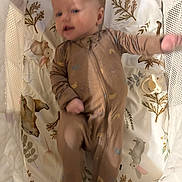 Logan joined the competition — help win amazing prizes! baby, infant, child, crib, crib_bumper, sleepwear, onesie, patterned_bedding, woodland_animals, bunny, stuffed_animal, pacifier, mesh, lying_down, portrait, indoor, cozy, curious, outstretched_arm, nursery