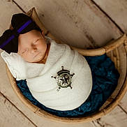 Magnolia is registered to the contest to win money with this photo: newborn, baby, sleeping, wrapped, blanket, bow, headband, badge, sheriff, wooden_bowl, blue_cloth, floor, rustic, cozy, portrait, indoor, peaceful, infant, cute, soft