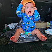Theoden is registered to the contest to win money with this photo: baby, baseballcap, box, cap, car, cartrunk, clothing, cushion, face, hat, head, person, photography, portrait, shorts, sitting, summer, t_shirt, transportation, vehicle