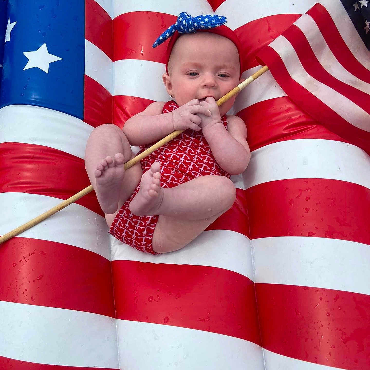 Gracie joined the competition — help win amazing prizes! americanflag, architecture, baby, baton, building, clothing, dress, face, flag, hat, head, newborn, outdoors, person, photography, portrait, shelter, sitting, stick, summer