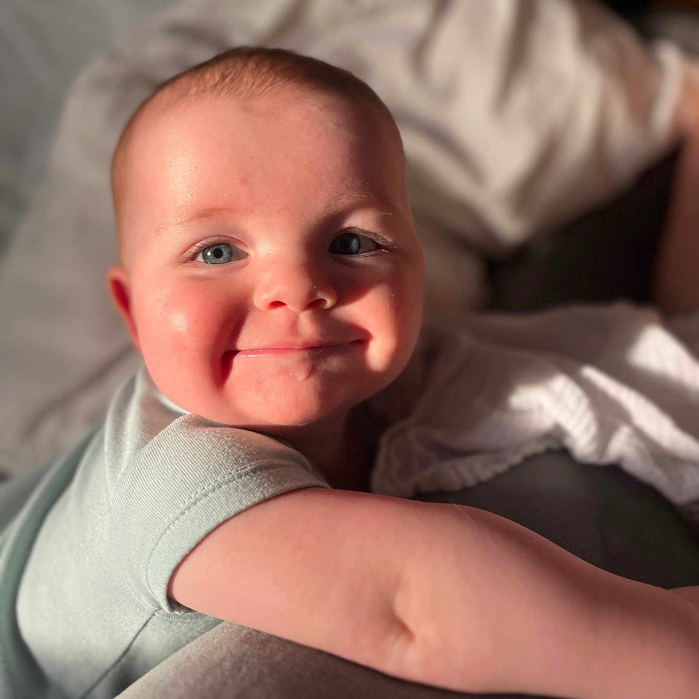 Ronan is registered to the contest to win money with this photo: baby, baby_boy, baby_girl, blanket, blue_eyes, child, close_up, clothing, couch, cute, face, happy, indoor, infant, portrait, rosy_cheeks, skin, smiling, soft_light, young