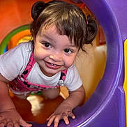 Gianna joined the competition — help win amazing prizes! toddler, child, smiling, pigtails, playground, plastic, colorful, crawling, happy, face, white_shirt, pink_overall, indoor, toy, fun, cute, young_child, play, curious, hands