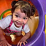 toddler, child, smiling, pigtails, playground, plastic, colorful, crawling, happy, face, white_shirt, pink_overall, indoor, toy, fun, cute, young_child, play, curious, hands