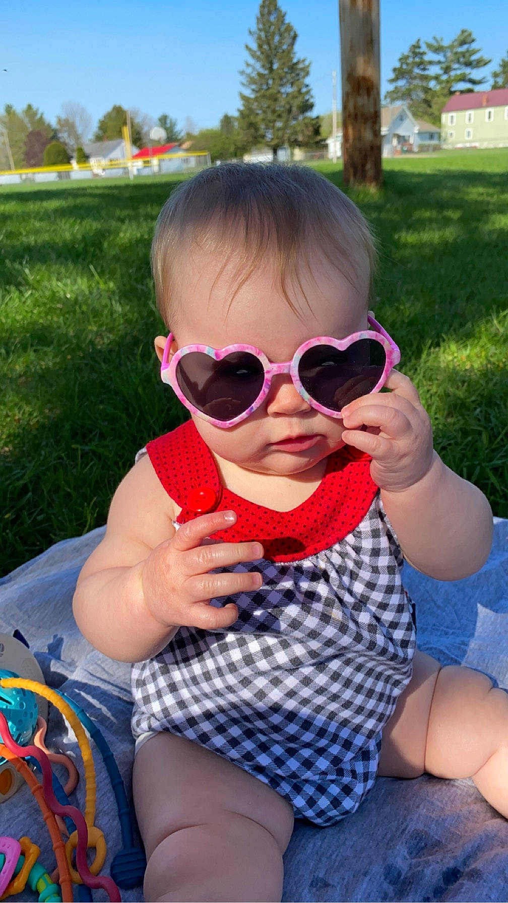 Avayah is registered to the contest to win money with this photo: baby_toddler_clothing, cool, eyewear, finger, fun, glasses, goggles, grass, happy, leisure, lip, person, personal_protective_equipment, pink, plant, recreation, sky, sunglasses, toddler, tree