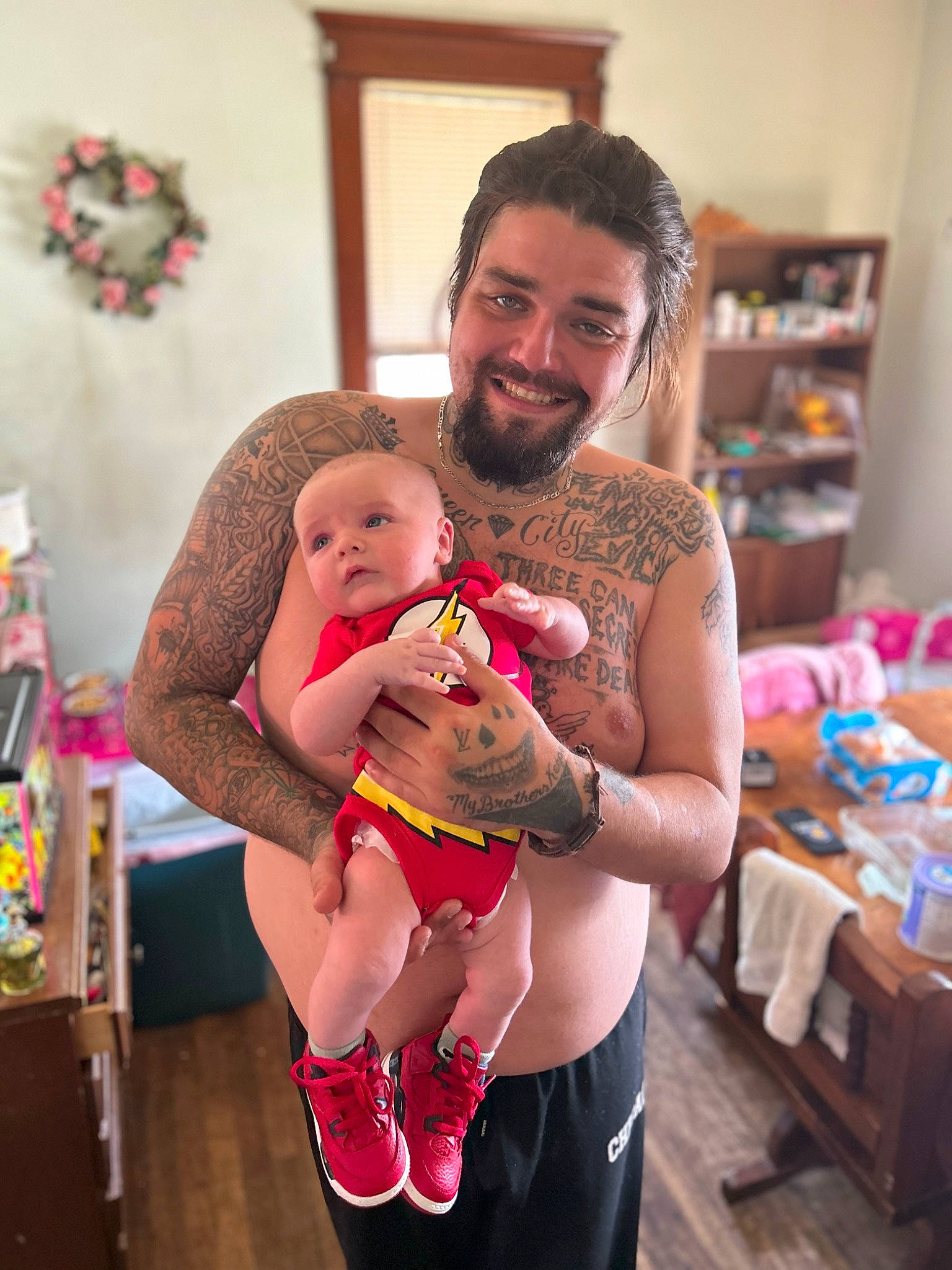 Jaxon is registered to the contest to win money with this photo: abdomen, baby, beard, child, event, fun, hand, happy, holiday, human_leg, joy, lap, navel, person, pink, room, shorts, smile, stuffed_toy, thigh