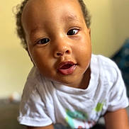 Isaiah participe au concours pour gagner de l'argent avec cette photo : baby, child, face, curious, white_shirt, close_up, portrait, indoor, infant, cute, young_child, skin, expression, person, toddler, hands, eyes, mouth, casual_clothing, soft_light