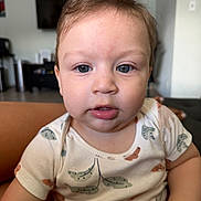 Isaac joined the competition — help win amazing prizes! baby, child, face, indoor, onesie, patterned_clothing, blue_eyes, short_hair, curious_expression, skin, person, portrait, furniture, television, living_room, couch, young_child, casual, sitting, closeup