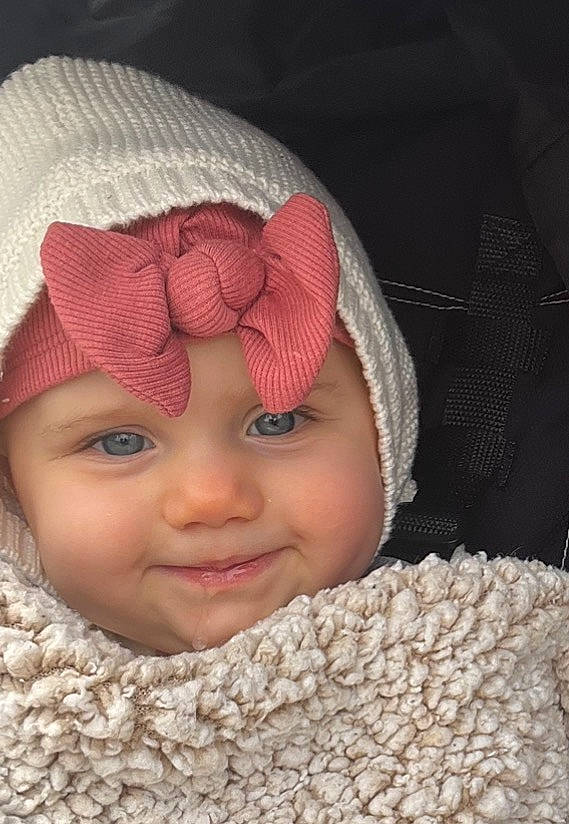 Everlee is registered to the contest to win money with this photo: baby, cap, cheek, comfort, eye, face, facial_expression, happy, headgear, headwear, knit_cap, lip, mouth, nose, outerwear, person, pink, skin, smile, textile