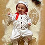 Oscar is registered to the contest to win money with this photo: baby, infant, snowman_costume, holiday, christmas, angel_wings, flour, powder, festive, smiling, cute, booties, headband, lights, decoration, holiday_outfit, lying_down, happy, child, indoors