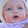 baby, child, face, hat, knitwear, scarf, pink, cream, blue_eyes, close_up, outdoor, adult, smiling, winter_clothing, portrait, curious_expression, person, headwear, warm_clothing, clear_sky