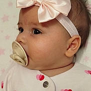 Gloria participe au concours pour gagner de l'argent avec cette photo : baby, infant, pacifier, headband, bow, pink, white_clothing, hearts, blanket, stars, face, profile, cute, sleepwear, child, newborn, soft_texture, adorable, lying_down, indoors
