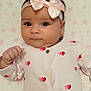 Gloria participe au concours pour gagner de l'argent avec cette photo : baby, infant, onesie, headband, bow, heart_pattern, blanket, star_pattern, cute, face, expression, clothing, sleepwear, lying_down, indoor, child, adorable, soft_toys, pink, white