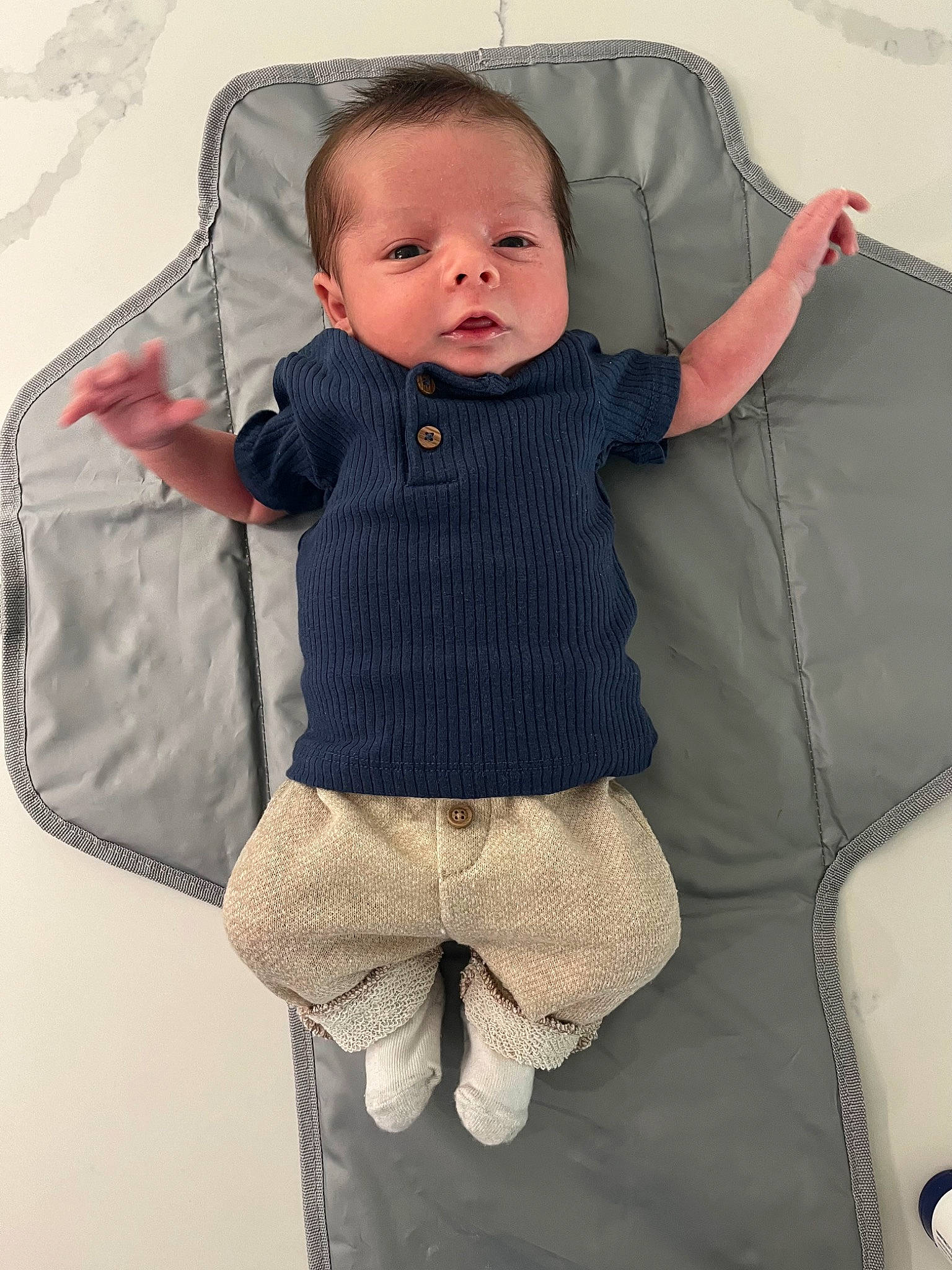 Sebastian joined the competition — help win amazing prizes! baby, baby_carriage, baby_products, baby_toddler_clothing, bag, chair, child, comfort, couch, face, grey, linens, luggage_and_bags, outerwear, pattern, person, sitting, sleeve, textile, throw_pillow