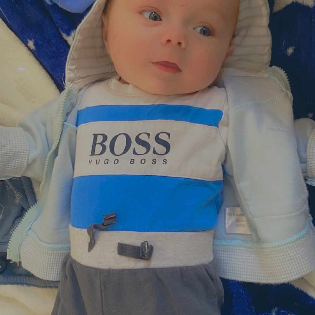 Ayden participe au concours pour gagner de l'argent avec cette photo : baby, bonnet, cap, clothing, coat, doll, face, glove, hat, head, hood, hoodie, knitwear, longsleeve, pants, person, sleeve, sweater, sweatshirt, toy