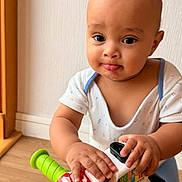 Emmanuel participe au concours pour gagner de l'argent avec cette photo : toddler, child, toy, indoor, play, curious, hands, face, expression, colorful, plastic, floor, wall, clothing, person, young, baby, grip, playful, fun