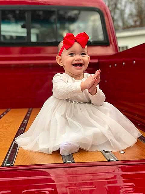 Madelynn is registered to the contest to win money with this photo: child, costume, day, flooring, fun, girl, gown, hair_accessory, happiness, headgear, joy, person, product, red, smile, toddler