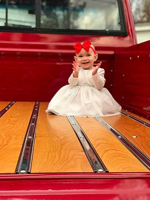 Madelynn is registered to the contest to win money with this photo: bridal_clothing, child, dress, floor, flooring, furniture, girl, gown, joy, person, product, red, table