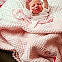 Bayley is registered to the contest to win money with this photo: baby, newborn, blanket, pink, pillow, sleeping, stretching, infant, soft_texture, cozy, clothing, indoor, cute, person, portrait, bed, resting, child, wrapped, toddler