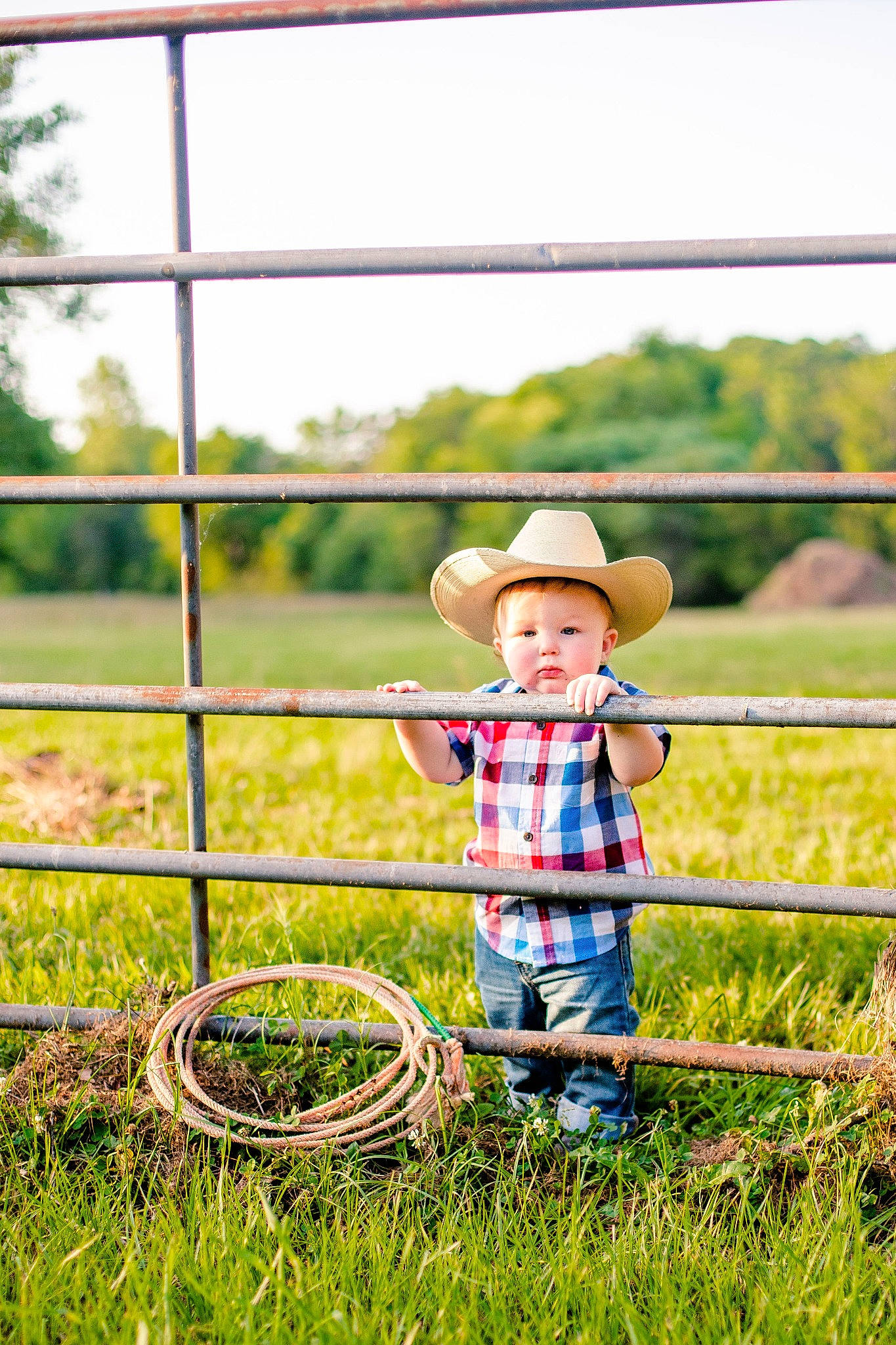 Landry joined the competition — help win amazing prizes! fence, fun, grass, grass_family, grassland, happy, hat, headgear, landscape, leaf, leisure, meadow, morning, people_in_nature, person, plant, rural_area, sky, sun_hat, toddler