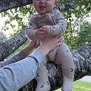 Paxton joined the competition — help win amazing prizes! baby, child, hands, tree, branch, greenery, outdoor, grass, pajamas, moon_pattern, nature, person, smiling, holding, infant, cute, daylight, playful, young, face