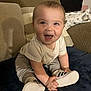 Paxton joined the competition — help win amazing prizes! baby, child, smiling, sitting, shoes, couch, cushion, indoor, happy, person, clothing, footwear, blanket, home, infant, cute, young, face, expression, casual