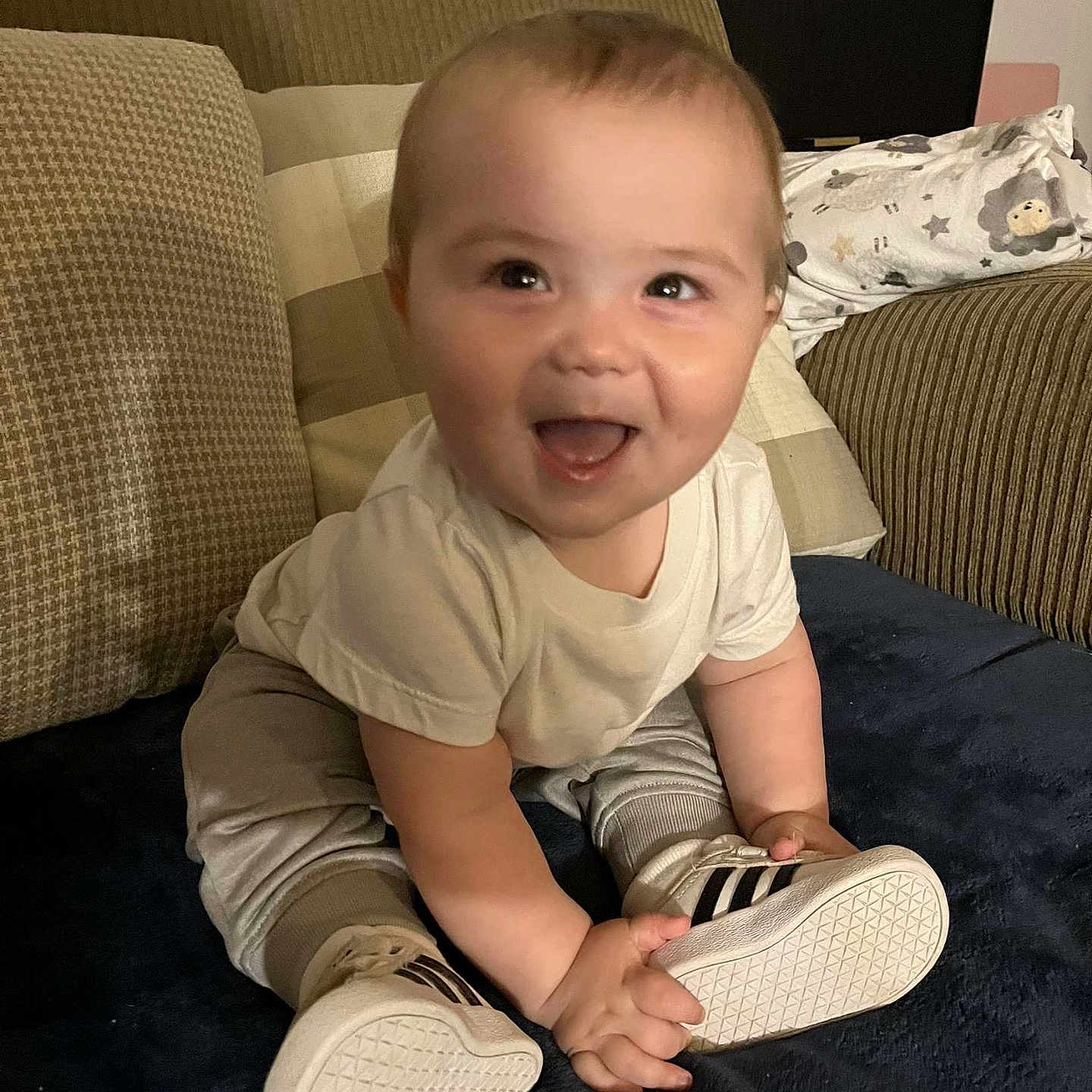 Paxton joined the competition — help win amazing prizes! baby, blanket, casual, child, clothing, couch, cushion, cute, expression, face, footwear, happy, home, indoor, infant, person, shoes, sitting, smiling, young