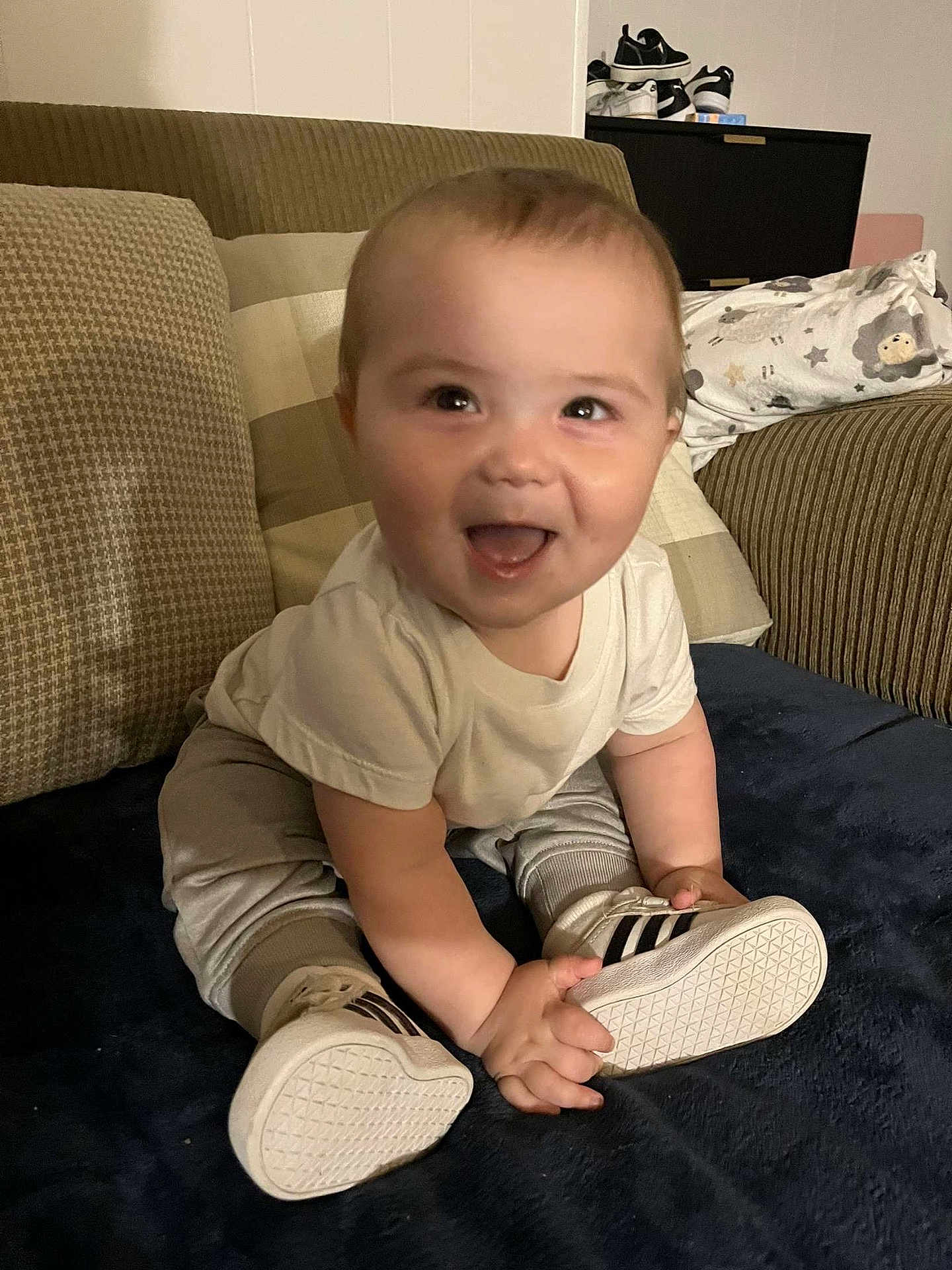Paxton joined the competition — help win amazing prizes! baby, child, smiling, sitting, shoes, couch, cushion, indoor, happy, person, clothing, footwear, blanket, home, infant, cute, young, face, expression, casual