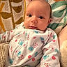 baby, infant, onesie, blanket, cozy, cute, sleepwear, patterned, animal_print, soft_texture, child, portrait, indoors, resting, newborn, young_child, warm, comfort, face, expressive_eyes