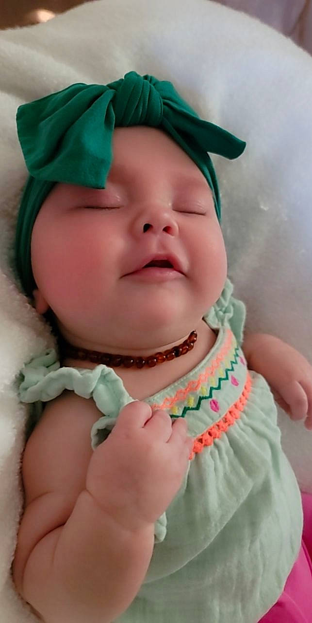 Rosemary is registered to the contest to win money with this photo: baby, baby_toddler_clothing, cheek, chin, eye, eyebrow, eyelash, face, finger, gesture, happy, hat, head, headwear, iris, lip, mouth, person, pink, skin