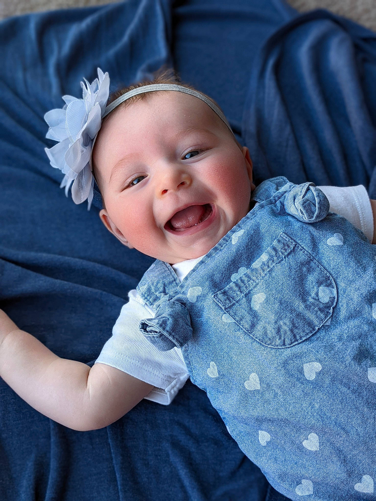 Raelynn is registered to the contest to win money with this photo: azure, baby, baby_toddler_clothing, beauty, blue, comfort, flash_photography, flower, happy, headwear, iris, pattern, person, pink, product, purple, skin, sleeve, smile, textile
