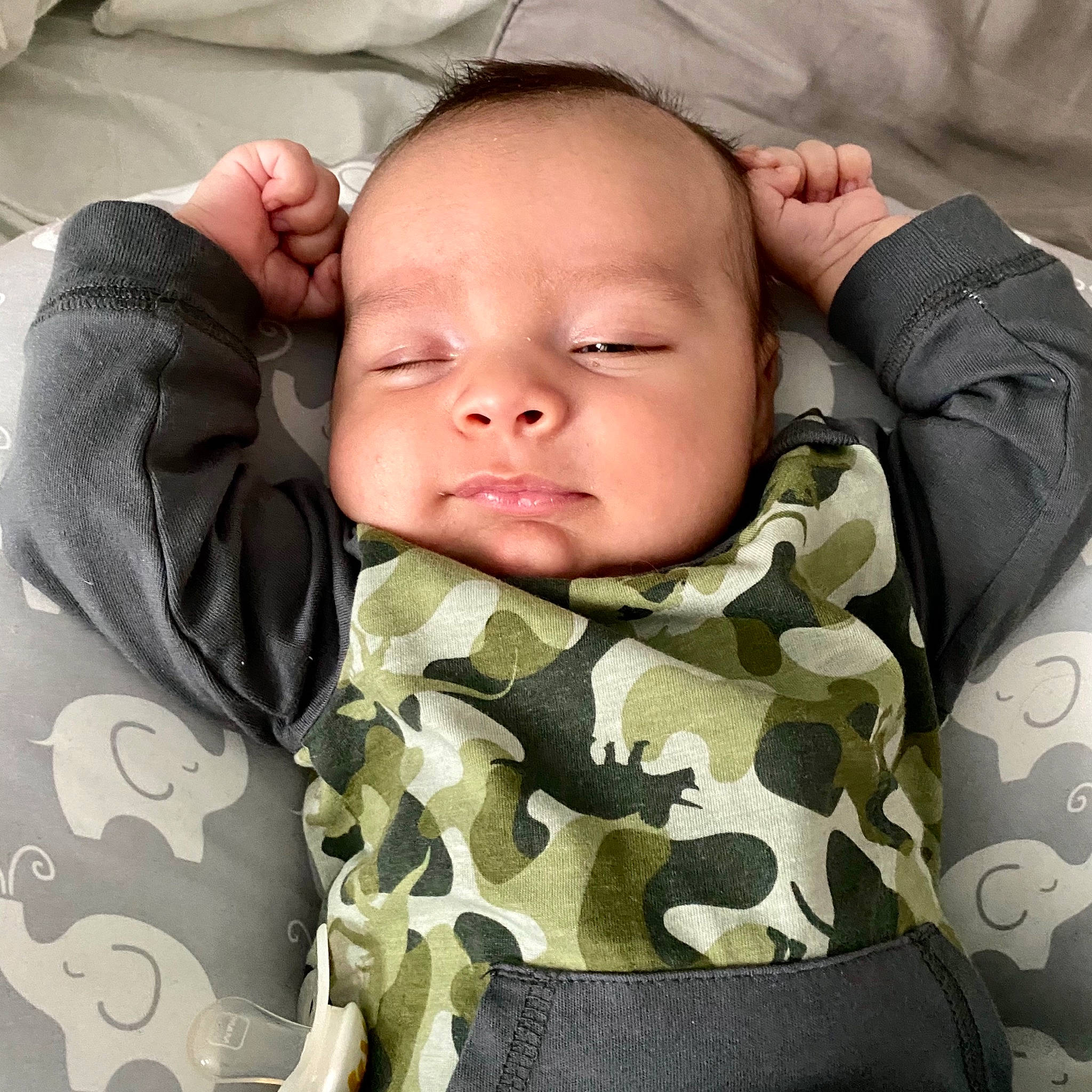 Lennon joined the competition — help win amazing prizes! baby, baby_sleeping, baby_toddler_clothing, camouflage, cheek, chin, collar, comfort, cool, eyebrow, face, gesture, head, linens, military_camouflage, nose, person, skin, sleeve, textile