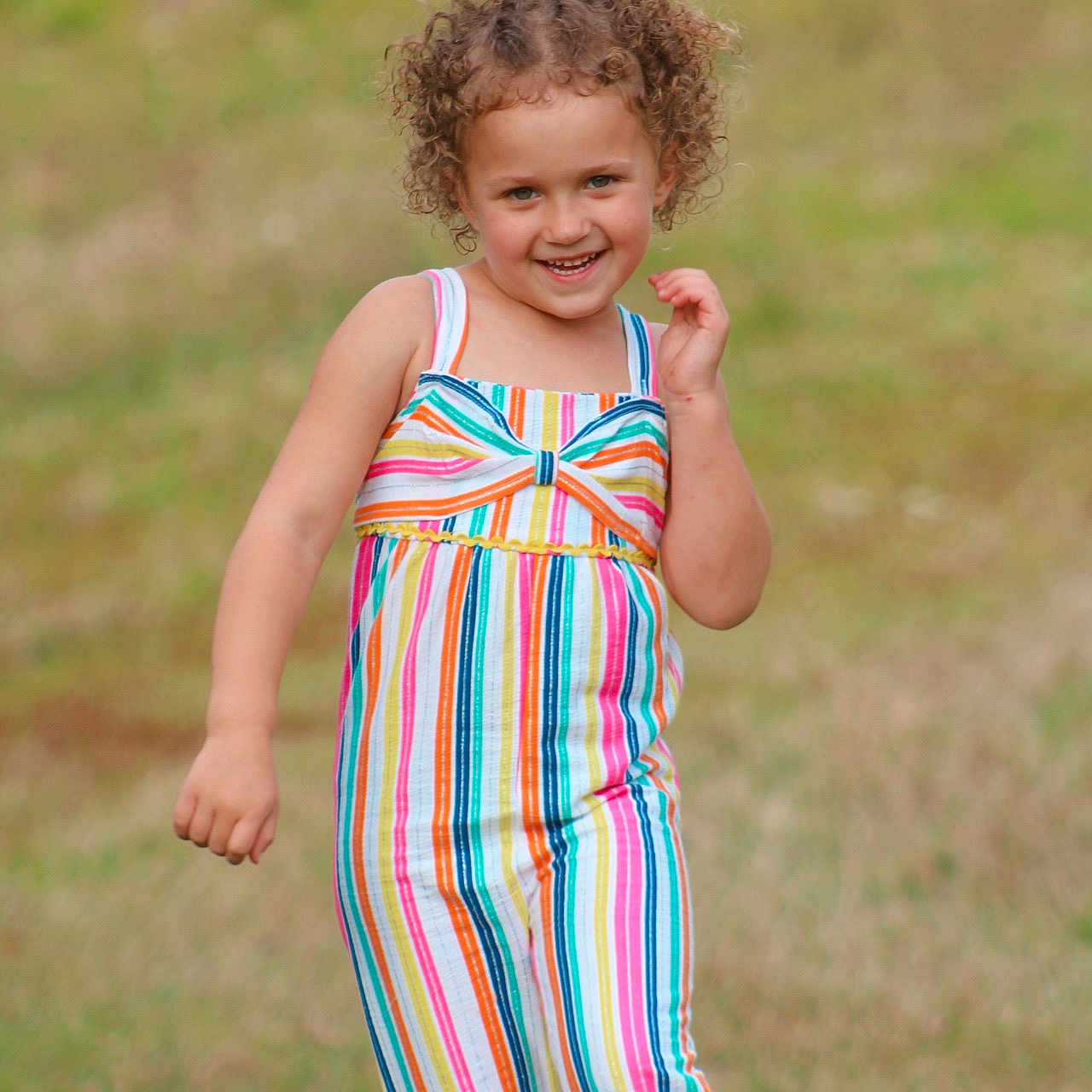 Mikiyah is registered to the contest to win money with this photo: bodypart, child, clothing, dress, face, female, finger, formalwear, girl, grass, hand, happy, head, lawn, pants, person, photography, plant, portrait, smile