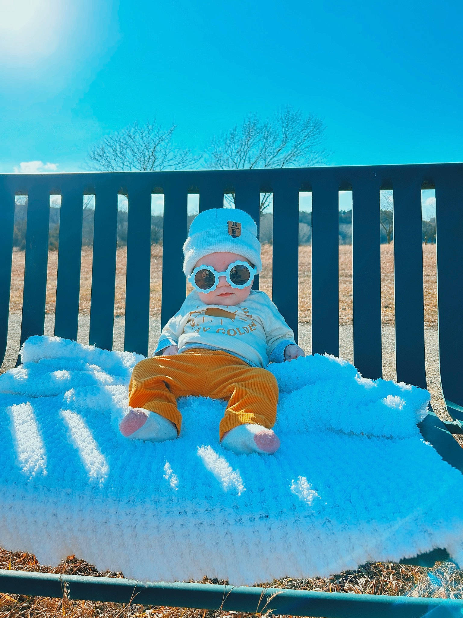 Rory is registered to the contest to win money with this photo: aqua, azure, blue, chair, comfort, eyewear, freezing, fun, goggles, grass, happy, leisure, outdoor_furniture, person, sky, snow, sunglasses, tree, vision_care, winter