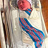 baby, bassinet, beanie, blanket, child, cute, healthcare, hospital, indoors, infant, maternity, newborn, peaceful, person, pillow, resting, sleeping, soft, striped, wrapped