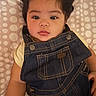 adorable, baby, bed, blanket, casual_clothing, child, close_up, curly_hair, denim, eyes, face, fashion, indoor, infant, looking_at_camera, lying_down, overalls, polka_dot, portrait, yellow_shirt