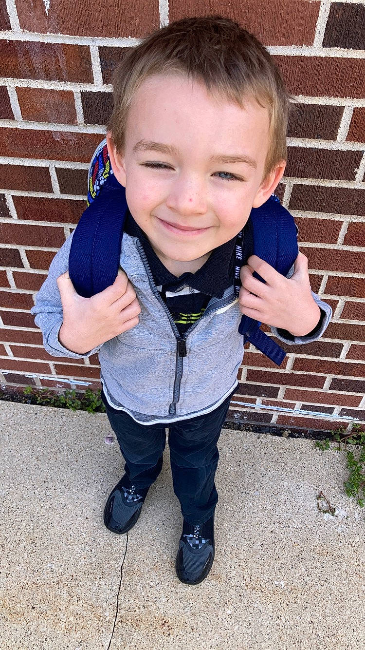 Gatlin is registered to the contest to win money with this photo: baby_toddler_clothing, brick, brickwork, child, collar, denim, electric_blue, flash_photography, fun, gesture, grass, happy, joy, laugh, nose, pattern, person, sitting, sleeve, smile