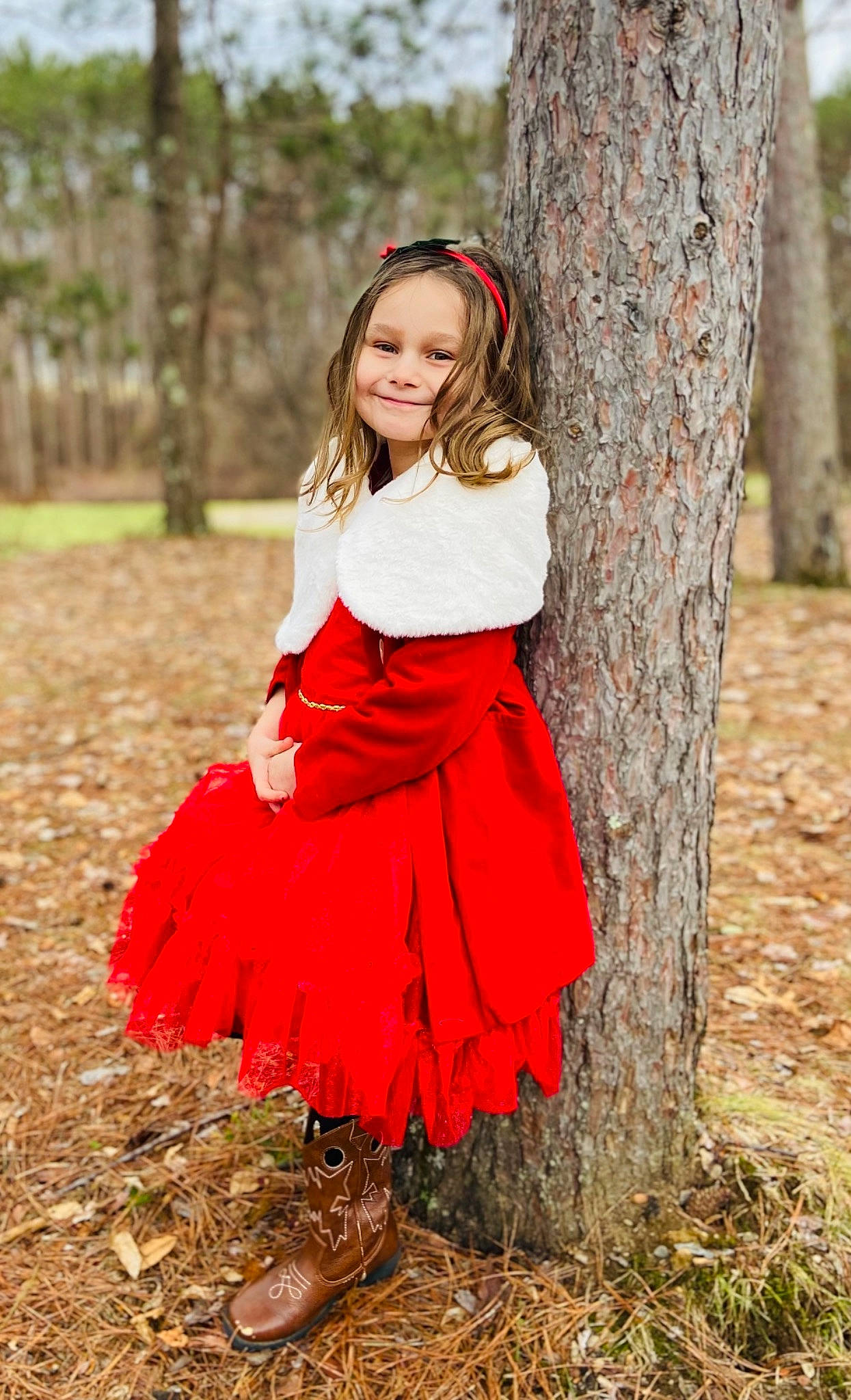 Natalie is registered to the contest to win money with this photo: child_model, clothing, costume_accessory, day_dress, deciduous, dress, embellishment, hair_accessory, happy, headband, joy, long_hair, maroon, people_in_nature, person, photo_shoot, portrait_photography, red, spring, trunk