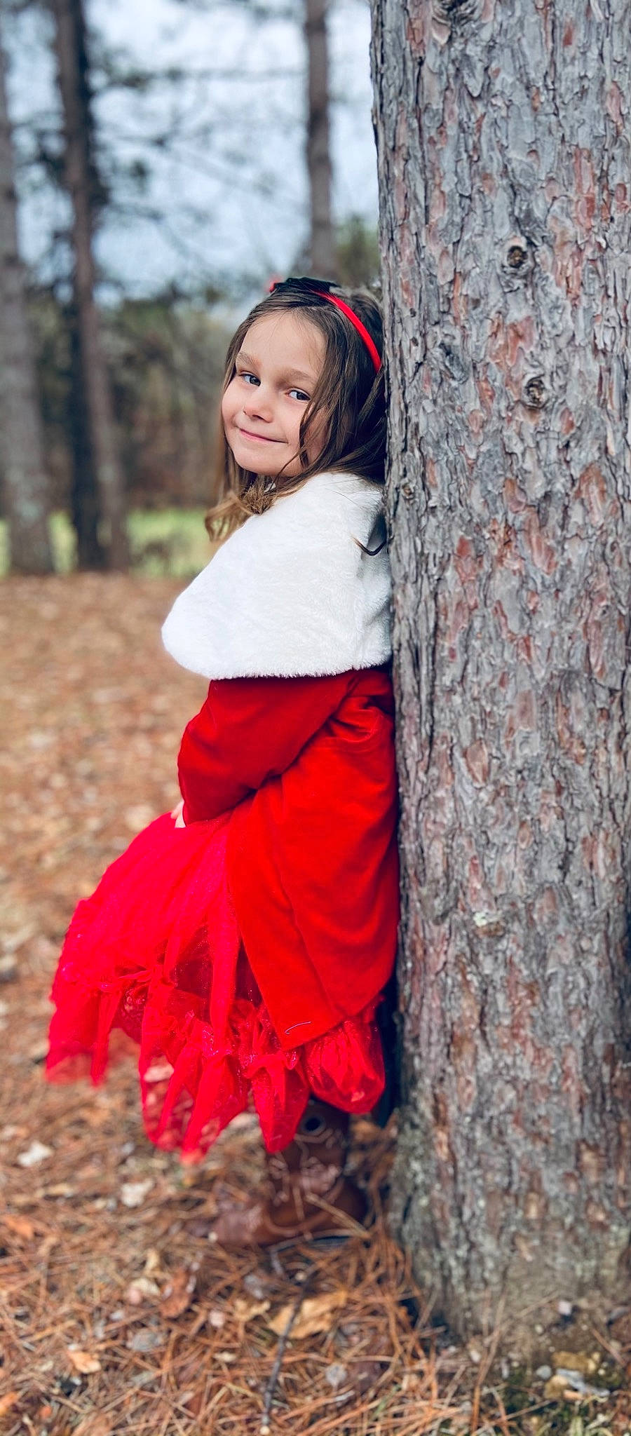Natalie is registered to the contest to win money with this photo: beauty, child_model, costume_accessory, day_dress, deciduous, hair_accessory, headband, headpiece, joy, long_hair, people_in_nature, person, photo_shoot, portrait_photography, ruffle, tradition, trunk, woodland