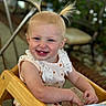 Bristol is registered to the contest to win money with this photo: baby, babylaughing, blonde, bodypart, clothing, dress, face, furniture, hair, happy, head, laughing, mouth, person, photography, portrait, sitting, smile, teeth, wood