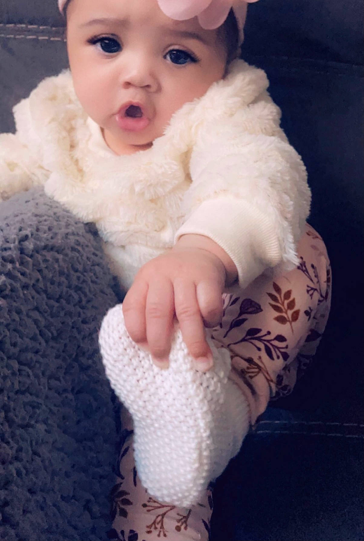 Kaelyn joined the competition — help win amazing prizes! baby, baby_toddler_clothing, cap, dress, eye, eyelash, finger, foot, human_body, iris, knee, lip, outerwear, person, skin, sleeve, sock, textile, toddler, white