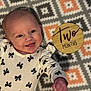 Serena joined the competition — help win amazing prizes! baby, infant, smiling, onesie, patterned_blanket, wooden_marker, two_months, face, happy, cute, lying_down, child, young_baby, black_bow_pattern, skin, head, arm, mouth_open, eyes, cheerful