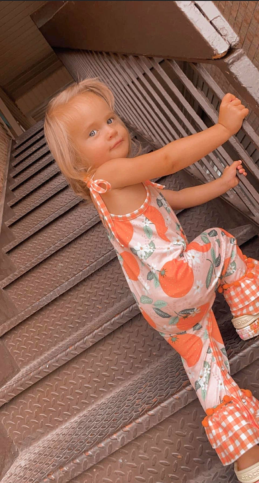 Madalynn joined the competition — help win amazing prizes! eye, fashion_design, flash_photography, flesh, flooring, foot, fun, head, human_leg, joint, knee, leg, leisure, muscle, orange, pattern, person, sitting, thigh, toddler