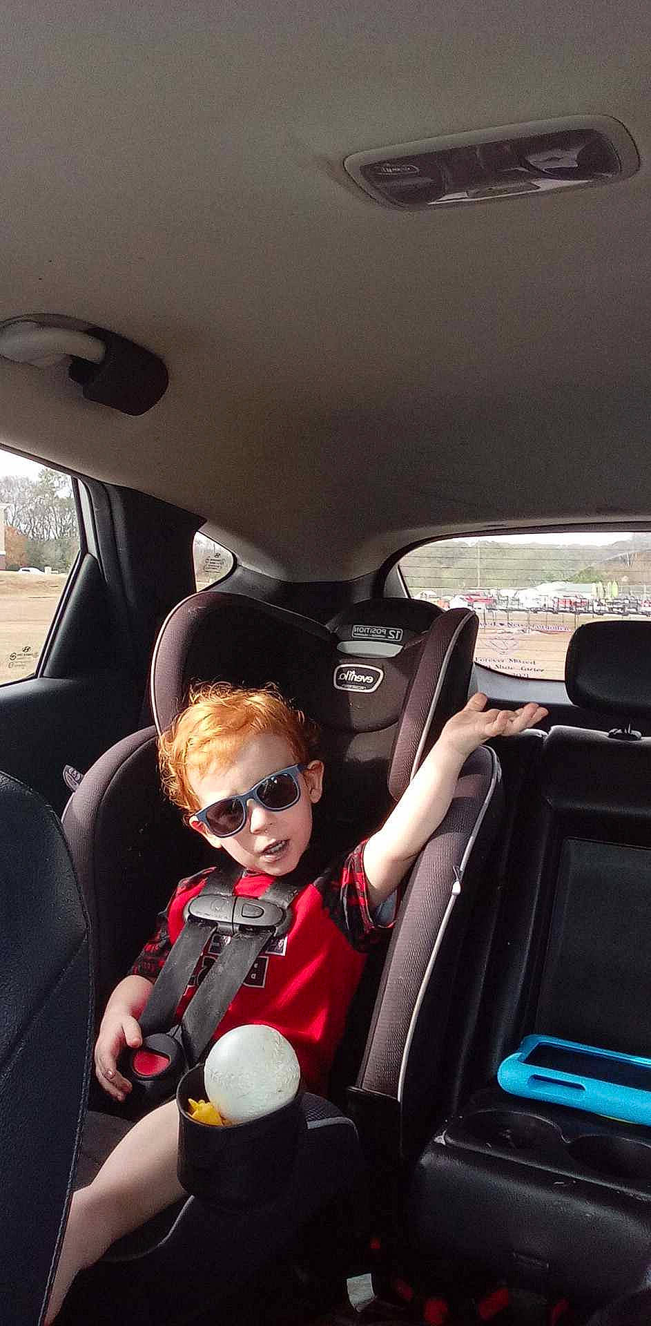 Will is registered to the contest to win money with this photo: auto_part, automotive_design, automotive_exterior, car, car_seat, car_seat_cover, eyewear, glasses, head_restraint, mode_of_transport, motor_vehicle, person, personal_luxury_car, plant, seat_belt, steering_part, steering_wheel, sunglasses, toddler, vehicle