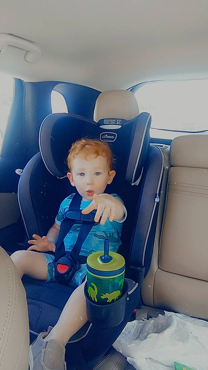 Will is registered to the contest to win money with this photo: airline, auto_part, automotive_design, baby, baby_toddler_clothing, car_seat, car_seat_cover, child, comfort, electric_blue, family_car, fun, head_restraint, luxury_vehicle, motor_vehicle, person, personal_luxury_car, recreation, sitting, surprise