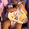 baby, child, car_seat, pink, bow, pacifier, soft_toy, baby_clothes, footwear, infant, cute, seated, indoors, sunlight, adorable, ribbons, clothing, person, young_child, baby_accessories