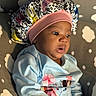Blessyn joined the competition — help win amazing prizes! baby, infant, child, bonnet, headwear, blue_shirt, floral_pattern, cushion, cloud_pattern, indoor, portrait, cute, curious, skin, face, eyes, mouth, sitting, clothing, soft
