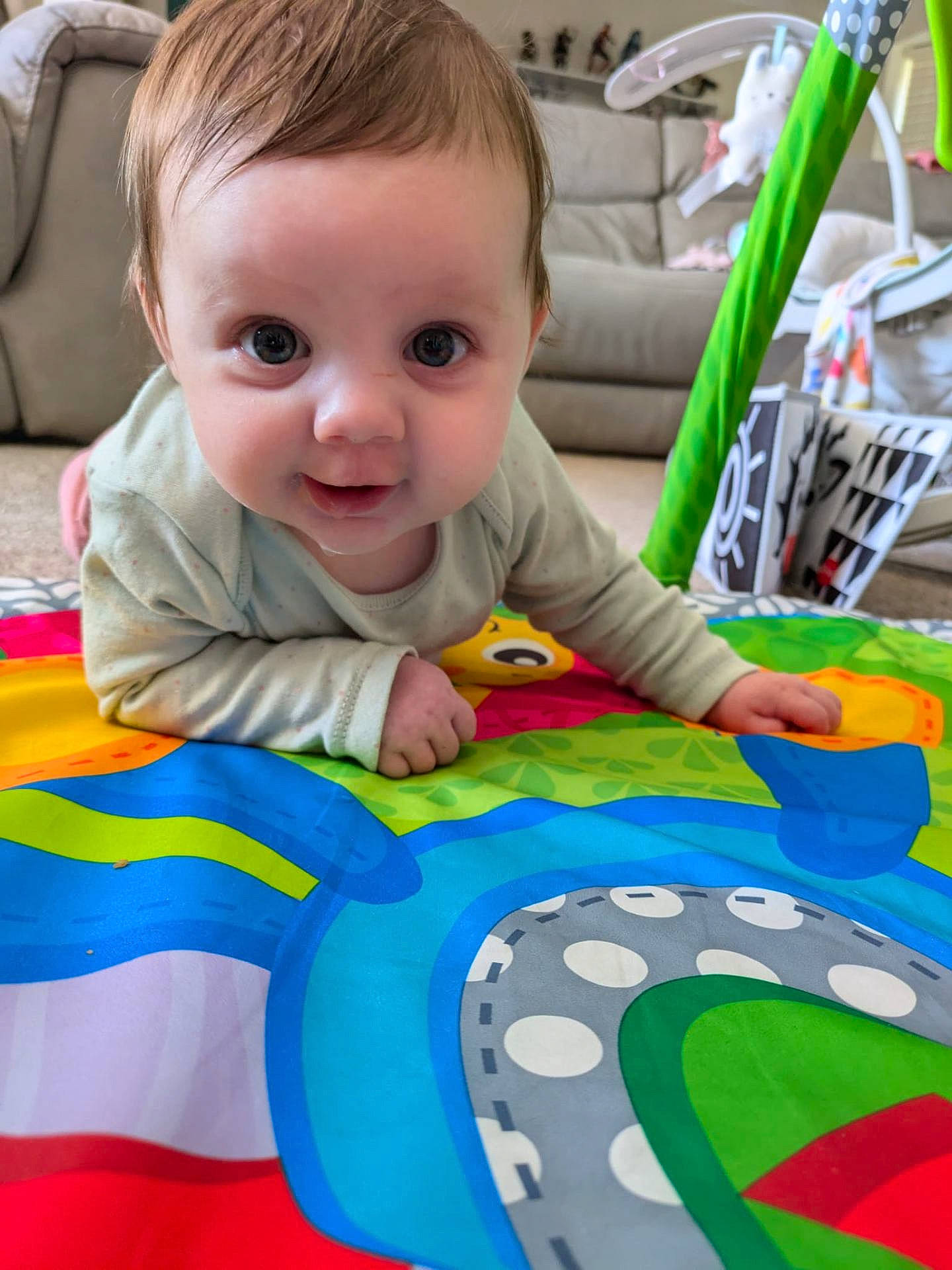 Evelyn is registered to the contest to win money with this photo: architecture, baby, blanket, building, clothing, couch, cushion, face, furniture, head, homedecor, indoors, interiordesign, person, photography, portrait, quilt, sitting, t_shirt, toy